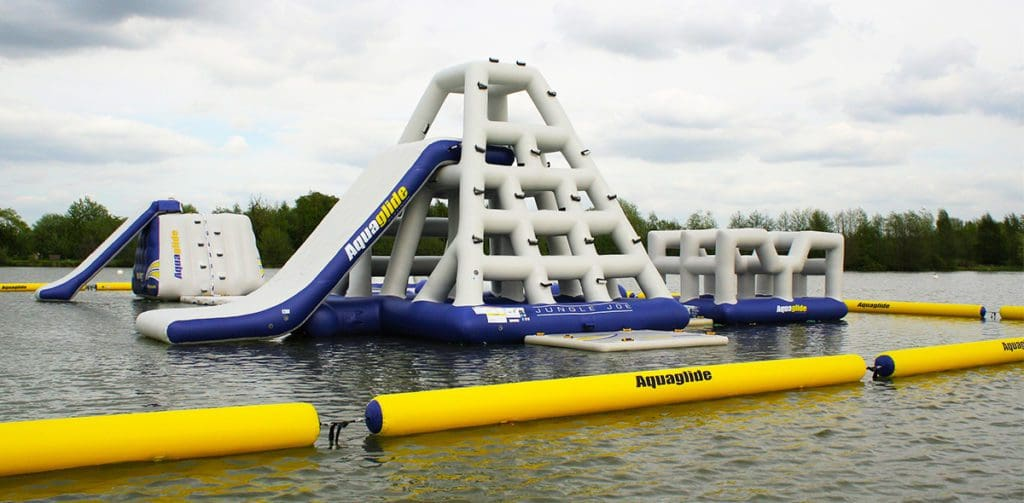 A large inflatable water park is floating on top of a lake.