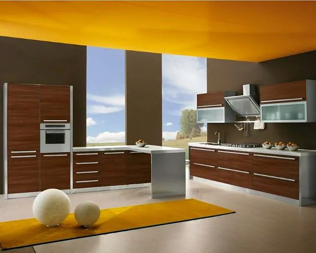 Una cocina con gabinetes de madera y electrodomésticos de acero inoxidable.