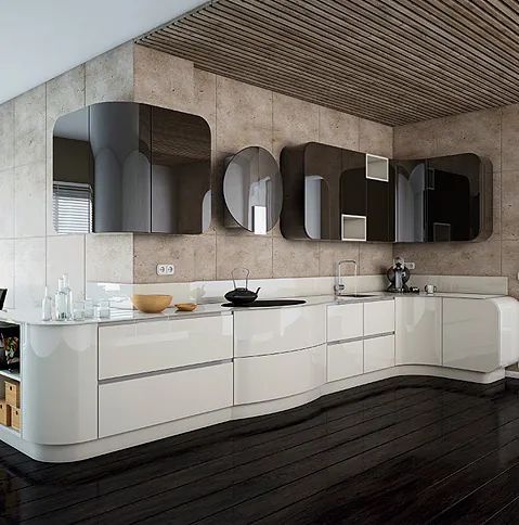 Una cocina moderna con gabinetes blancos y electrodomésticos negros.