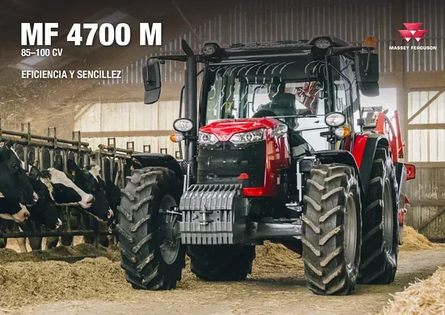 Un tractor rojo y negro está estacionado en un granero al lado de las vacas.