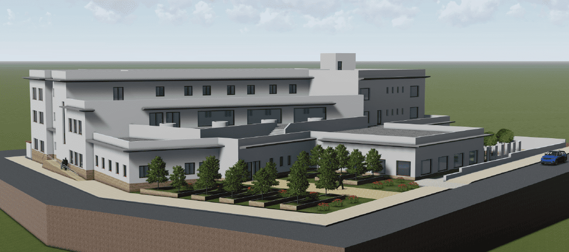 Una vista aérea de un gran edificio con árboles delante.