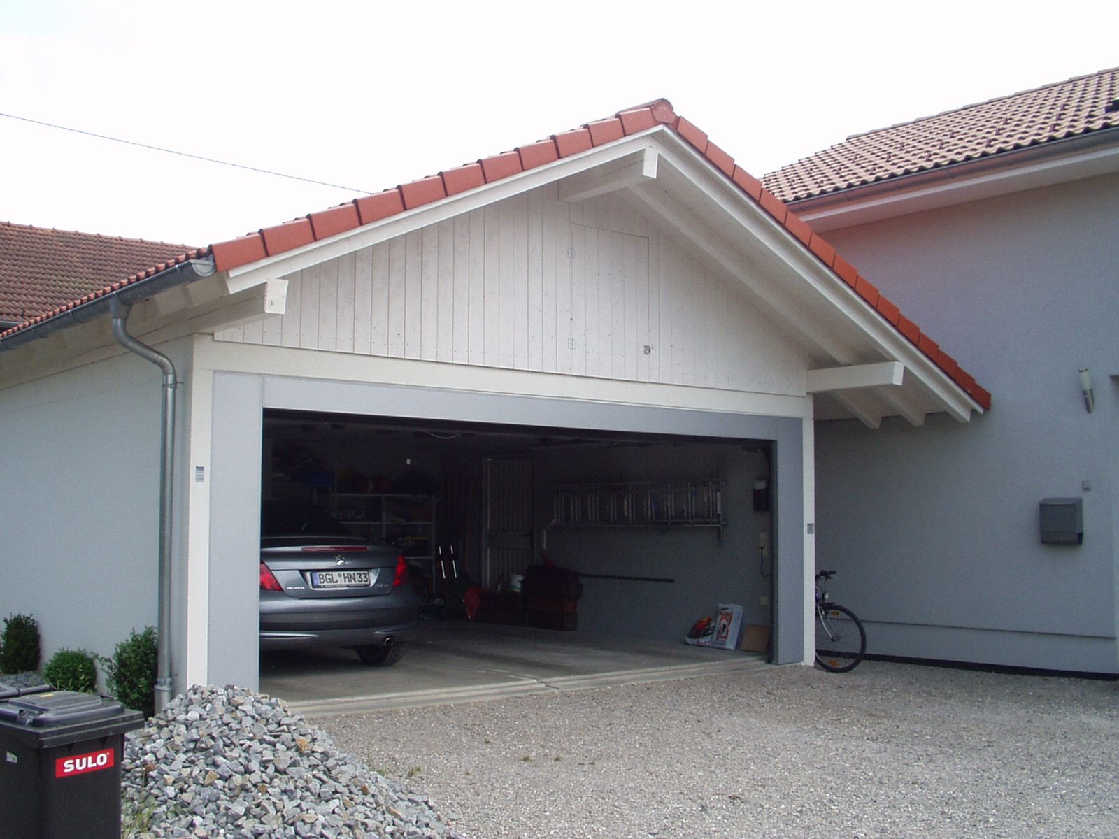 Offene Garage mit Dachstuhl und sichtbarer Holzkonstruktion