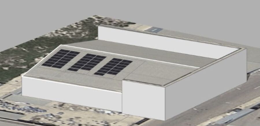 Una vista aérea de un edificio con paneles solares en el techo.