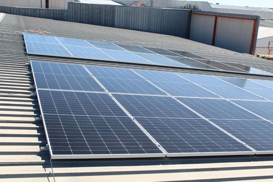 Una fila de paneles solares están colocados encima de un tejado.