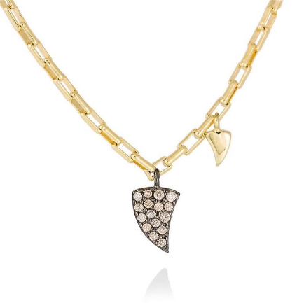 Un collar de cadena de oro con un colgante en forma de corazón.