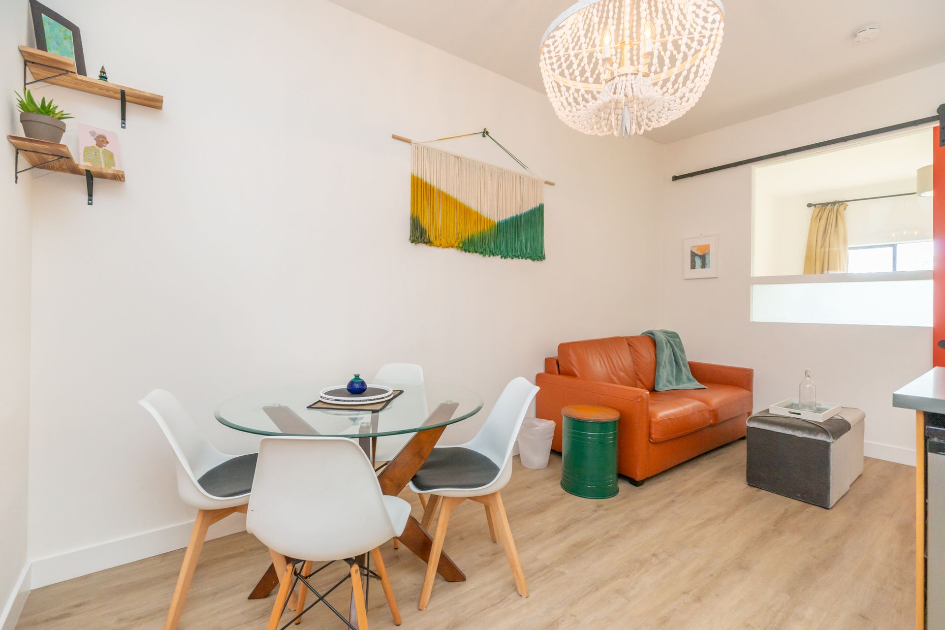 A living room with a couch , table and chairs.