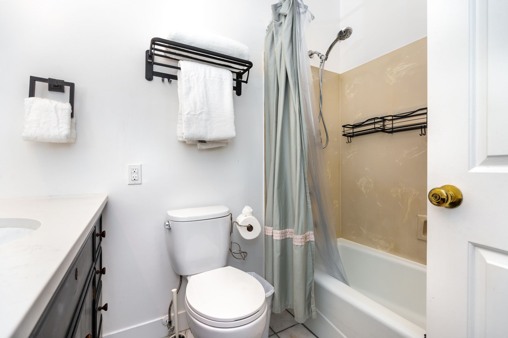 A bathroom with a toilet , sink , shower and bathtub.