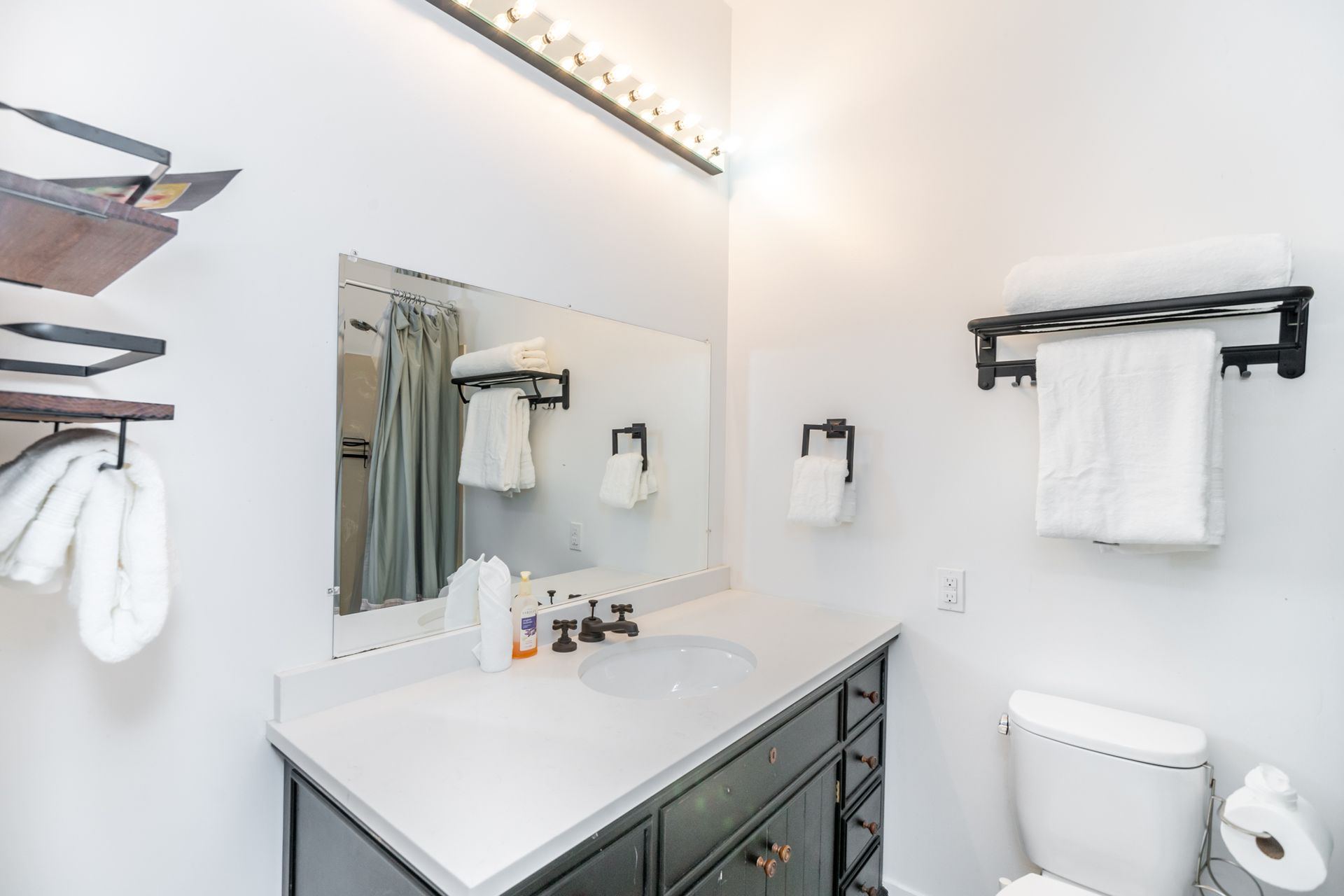 A bathroom with a sink , toilet and mirror.