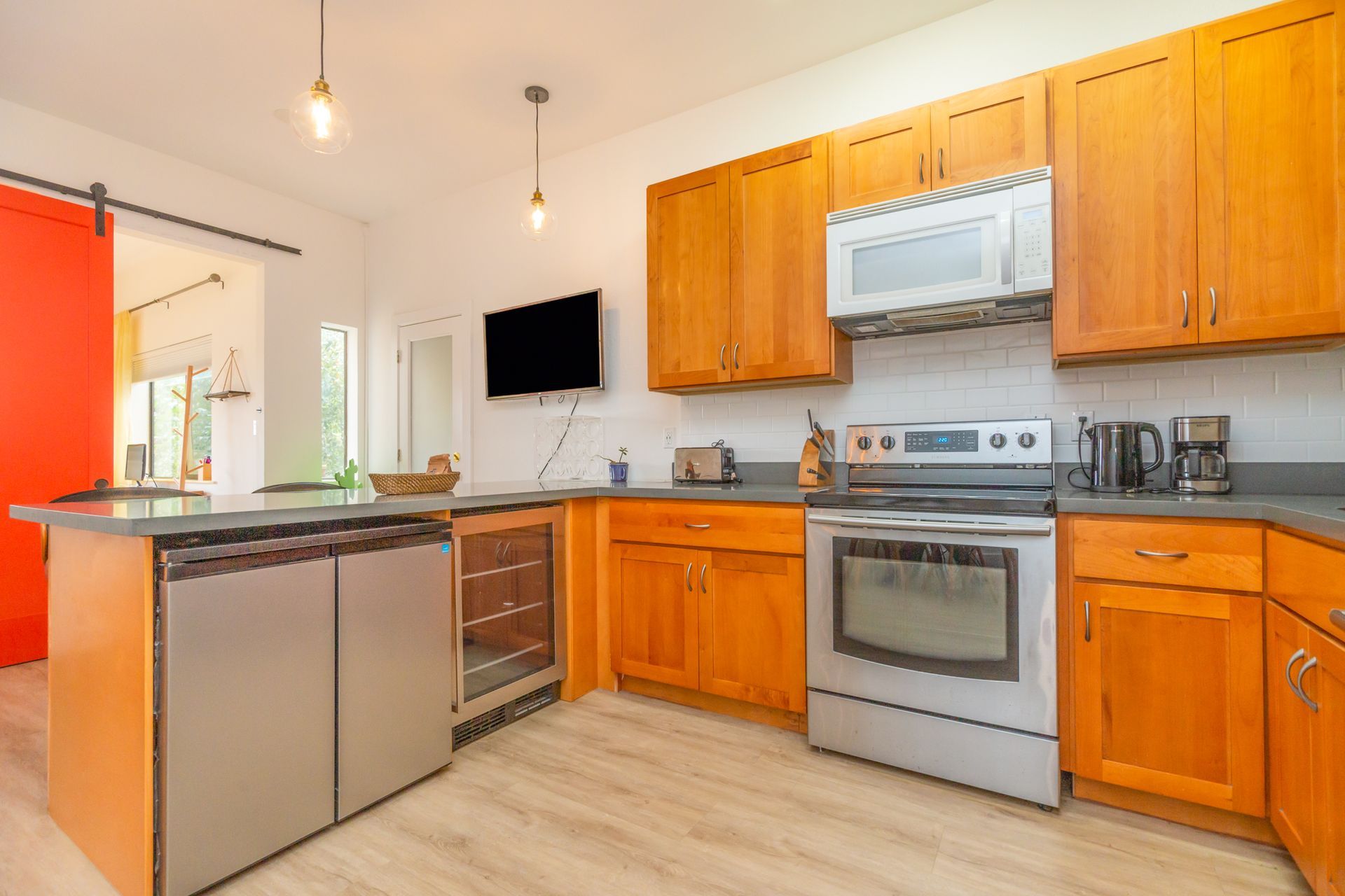 A kitchen with wooden cabinets and stainless steel appliances.