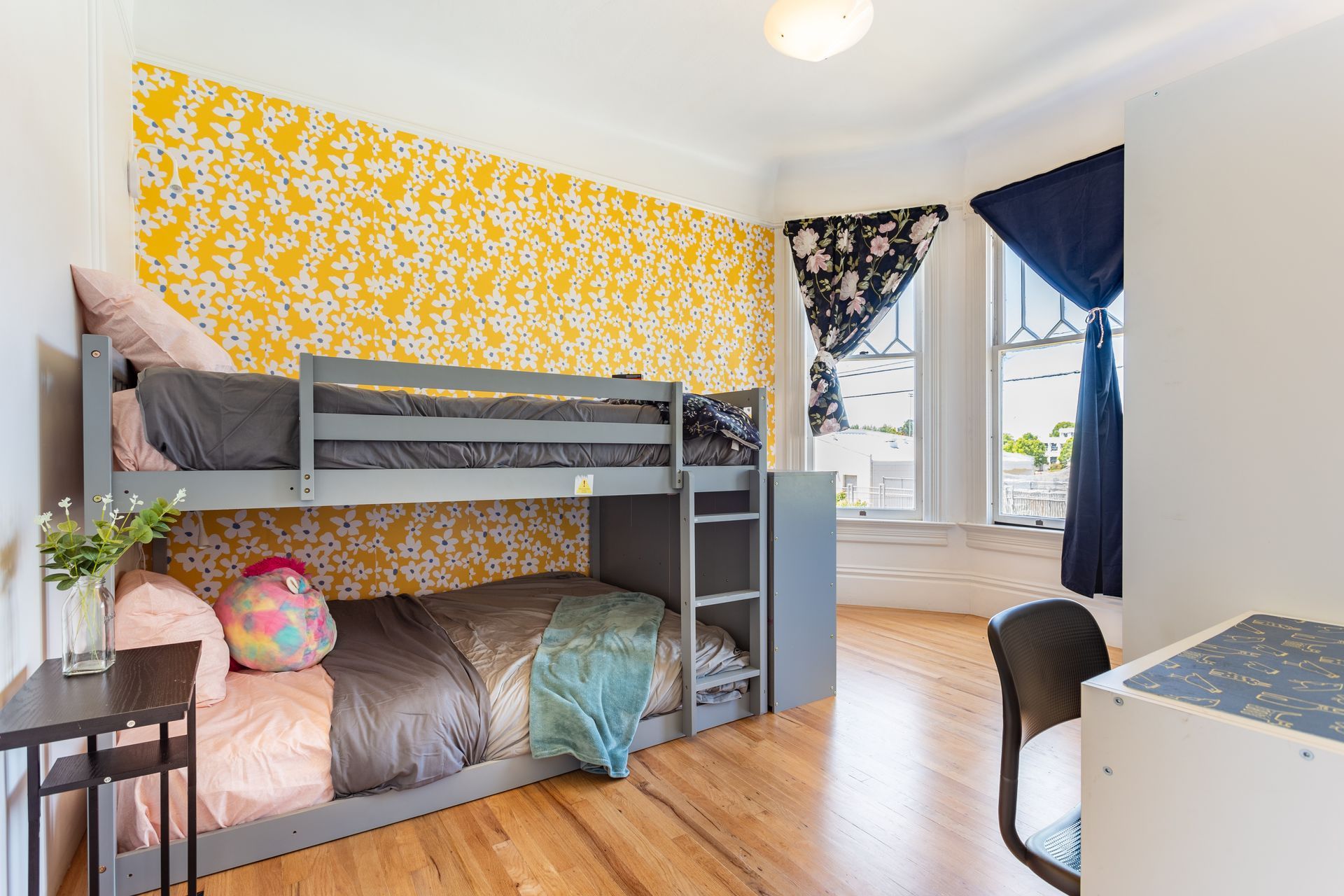 A bedroom with a bunk bed and a desk