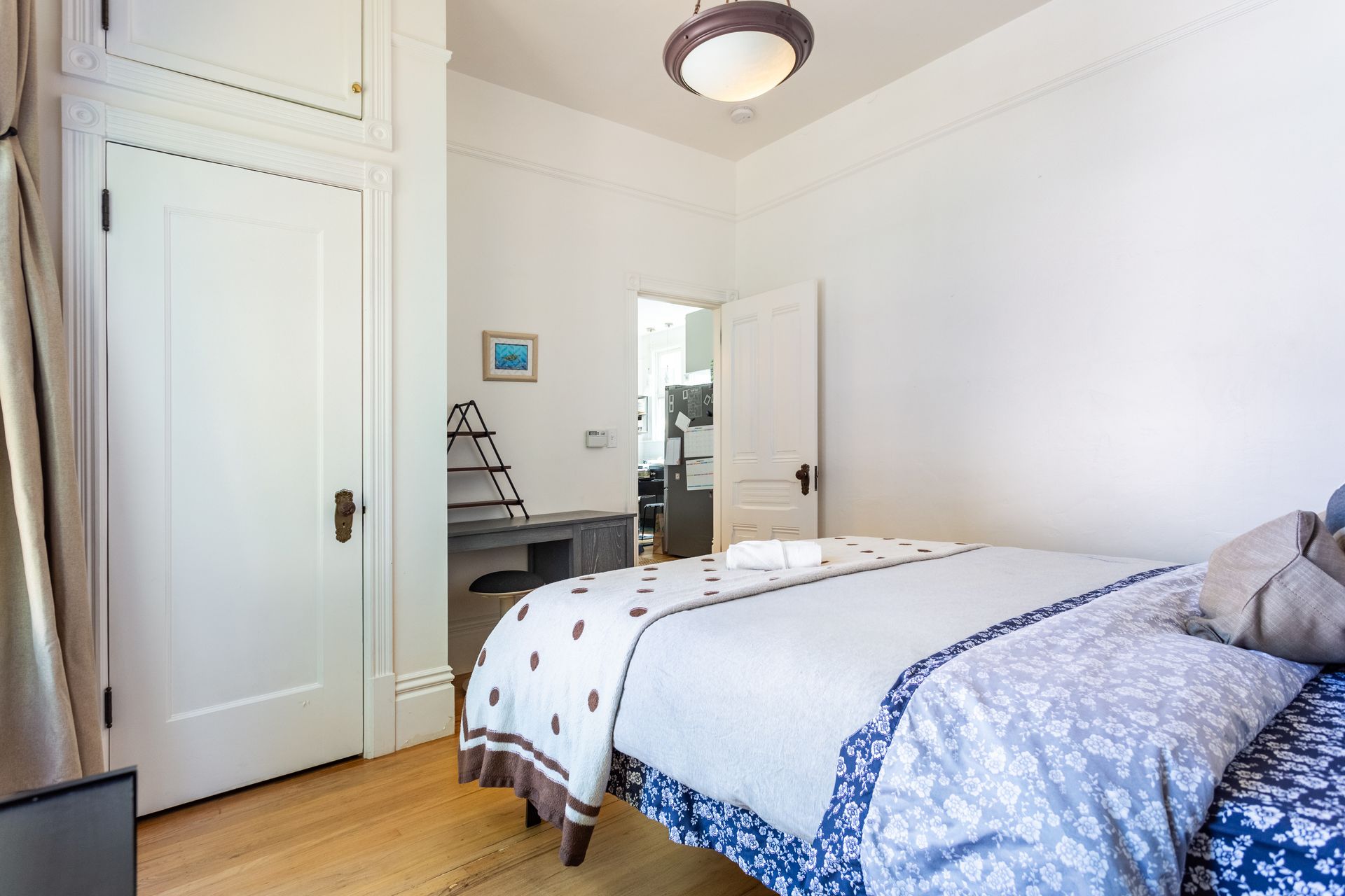 A bedroom with a bed and a closet.