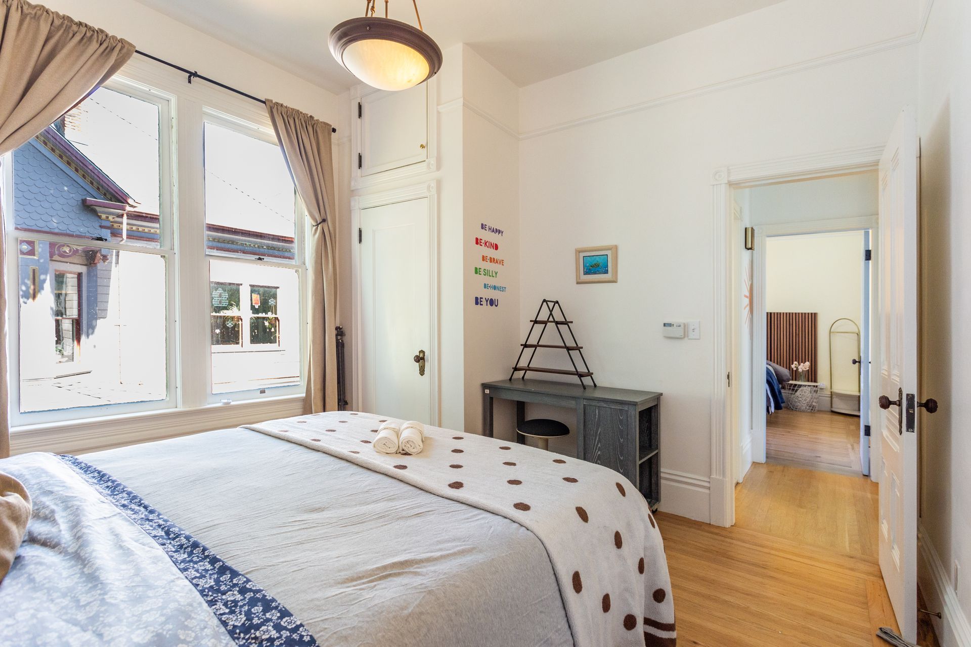 A bedroom with a king size bed and a window.