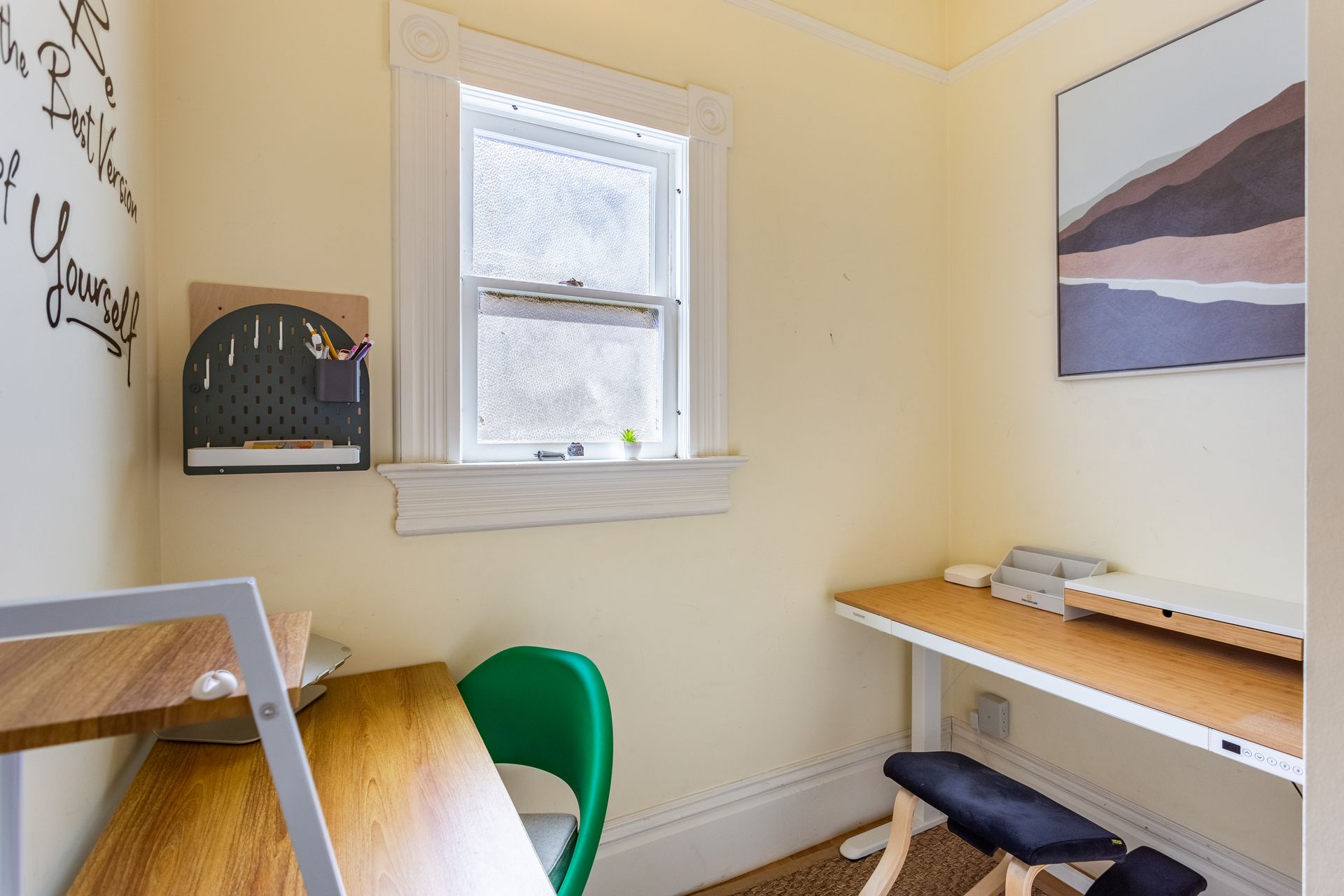 A small office with a desk , chair and window.