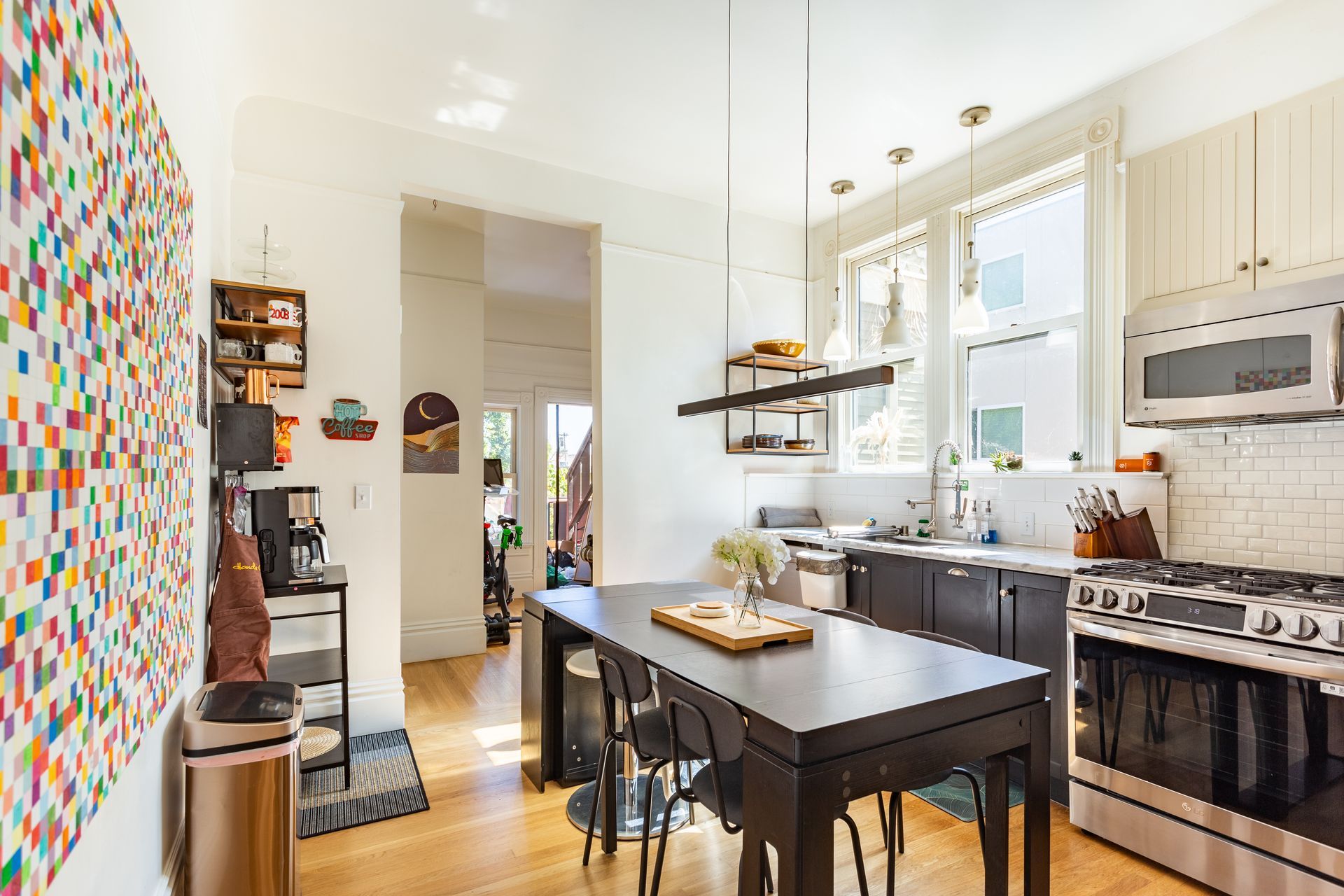 A kitchen with a table and chairs and a stove.
