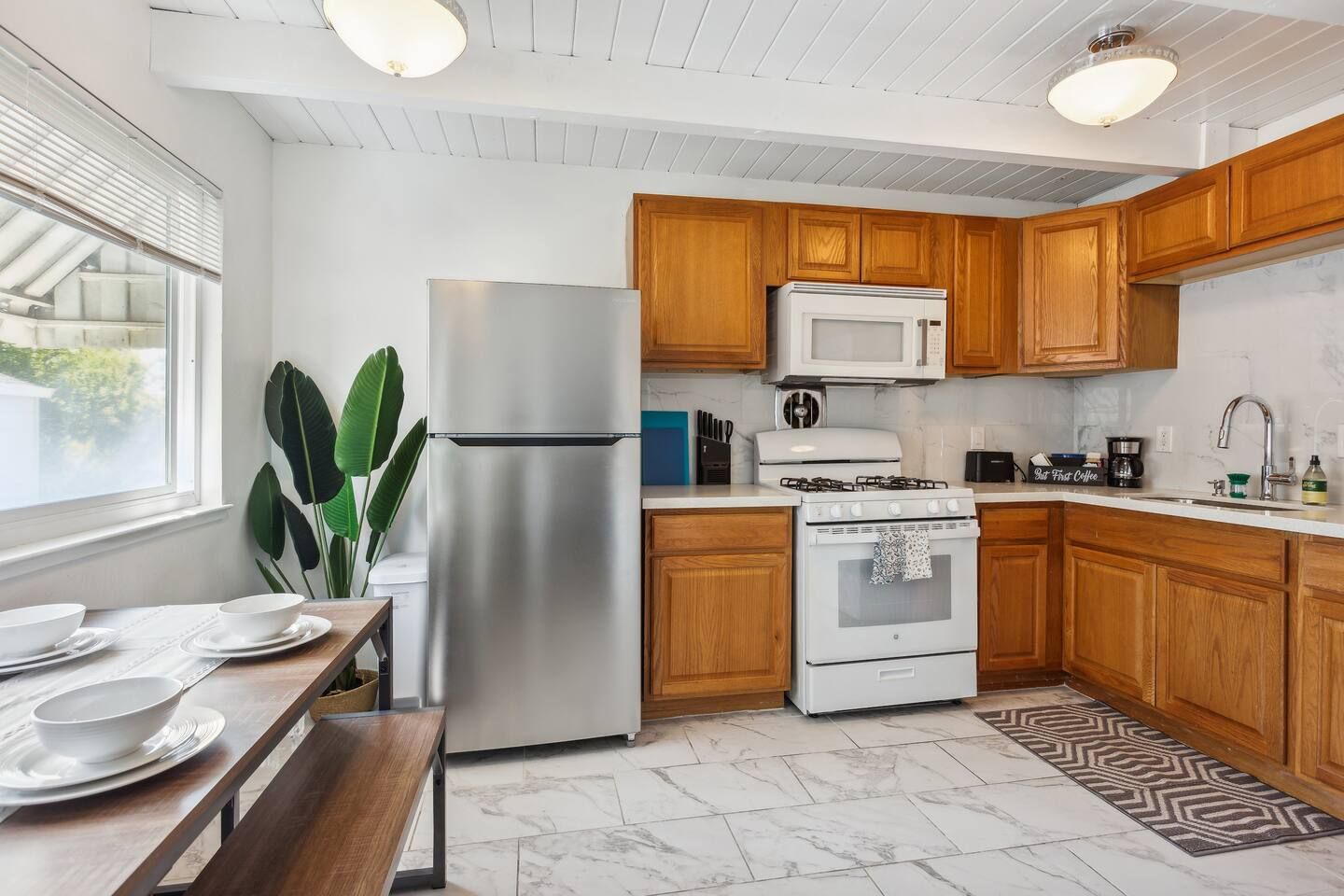A kitchen with stainless steel appliances and wooden cabinets.