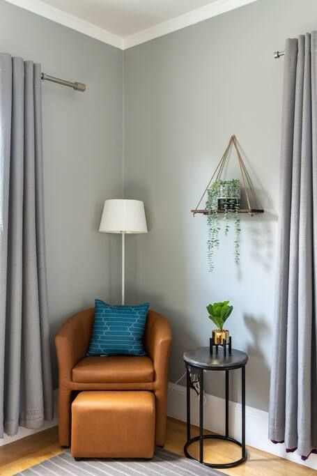 A living room with a chair , table and lamp