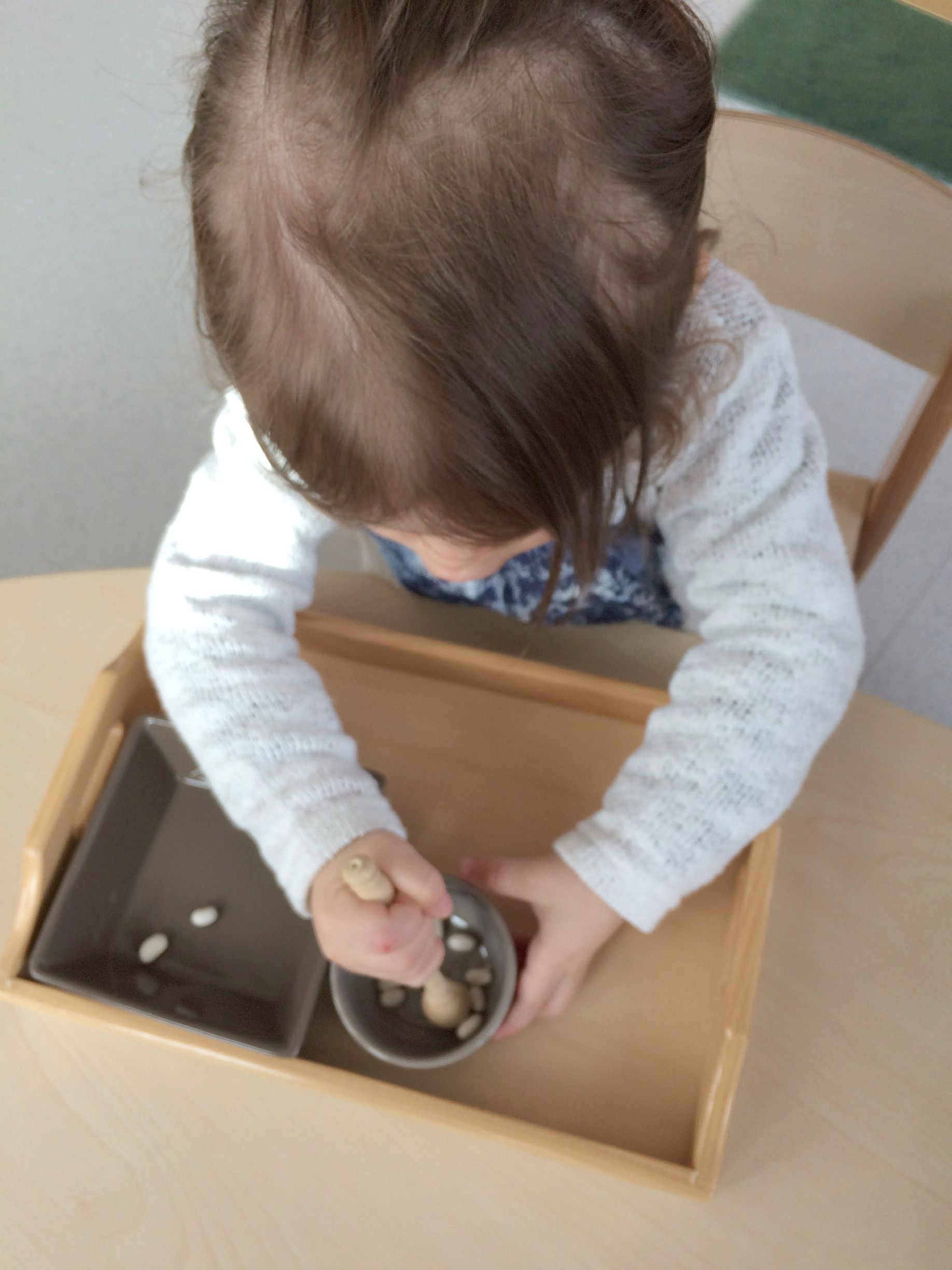 Enfant en train de jouer avec des graines 