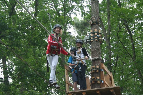 Ein Mädchen hat Spaß im Hochseilgarten