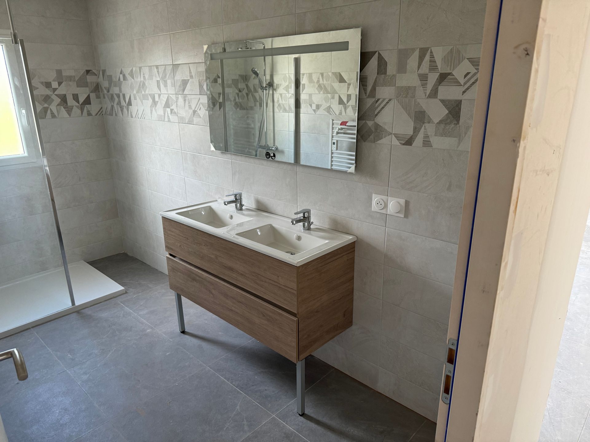 Installation d'un meuble avec une doubles vasques et un miroir mural