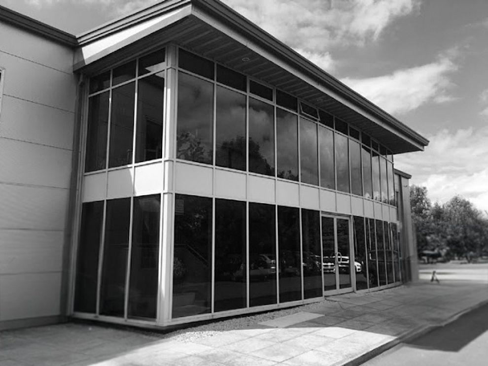 A black and white photo of a large building with lots of windows.