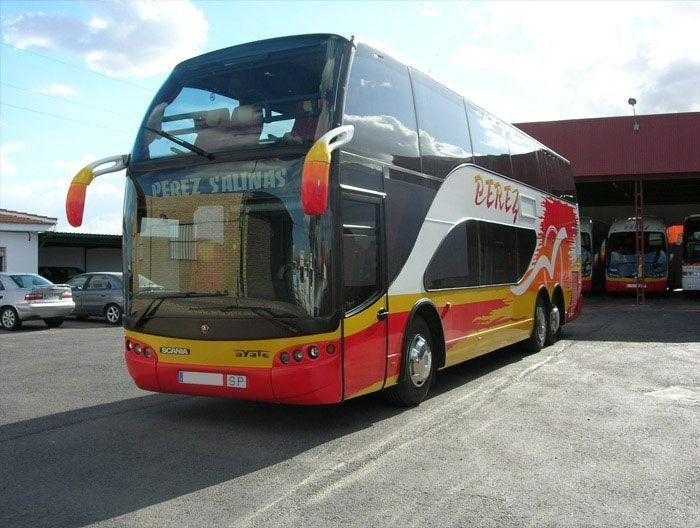 Un autobús de dos pisos está estacionado en un estacionamiento.