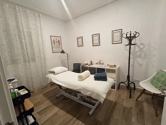 Una habitación con una cama y una silla dentro.