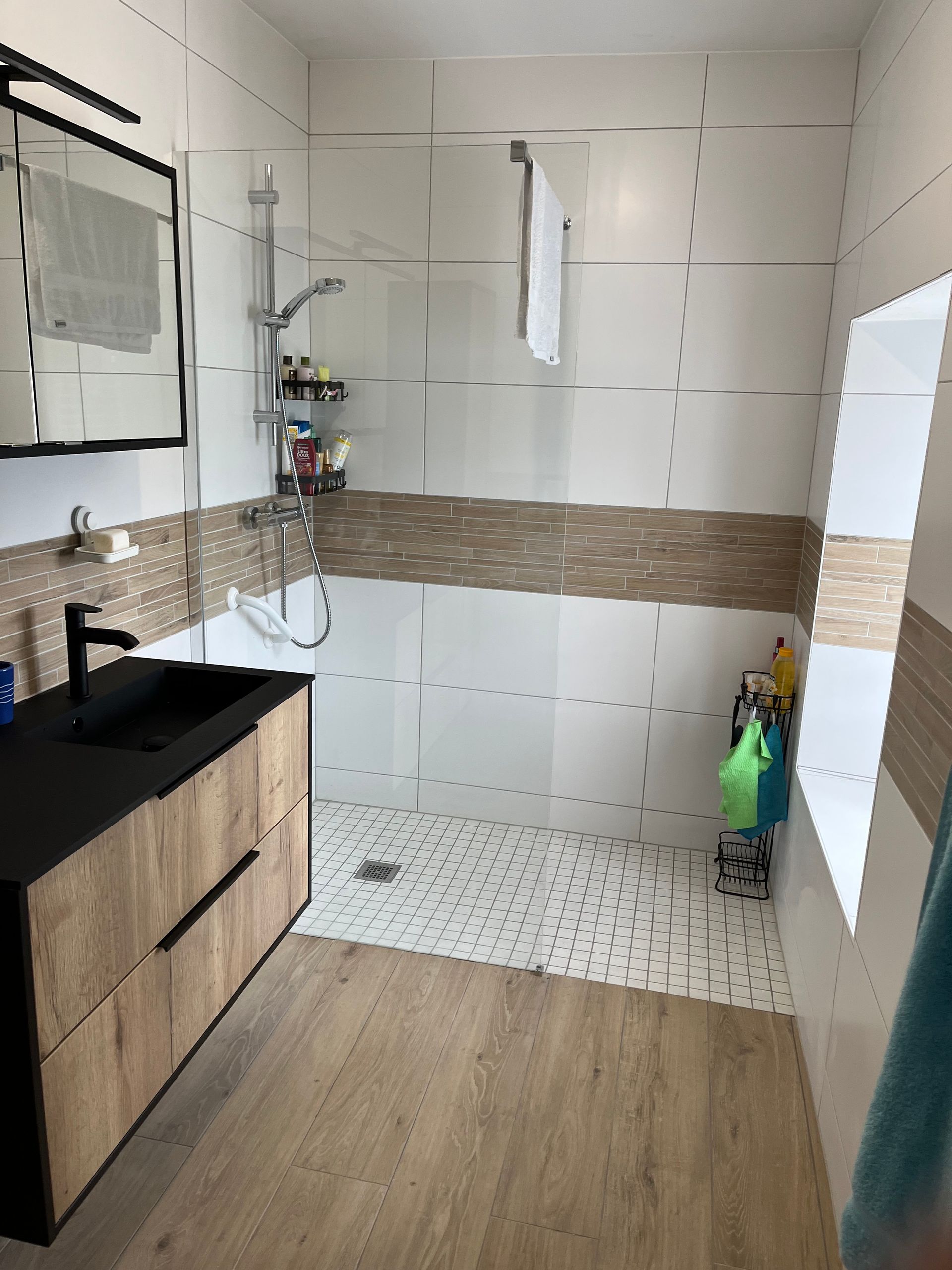 Salle de bains moderne avec meuble-lavabos, parquet et douche à l'italienne.
