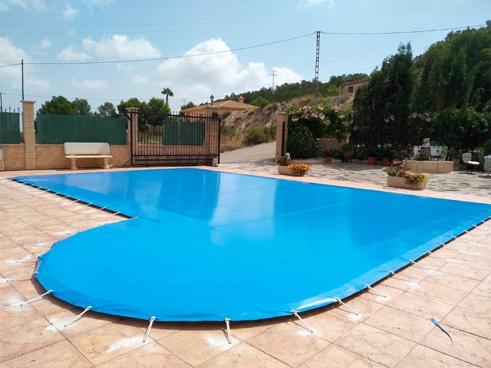 Una piscina con una cubierta azul.