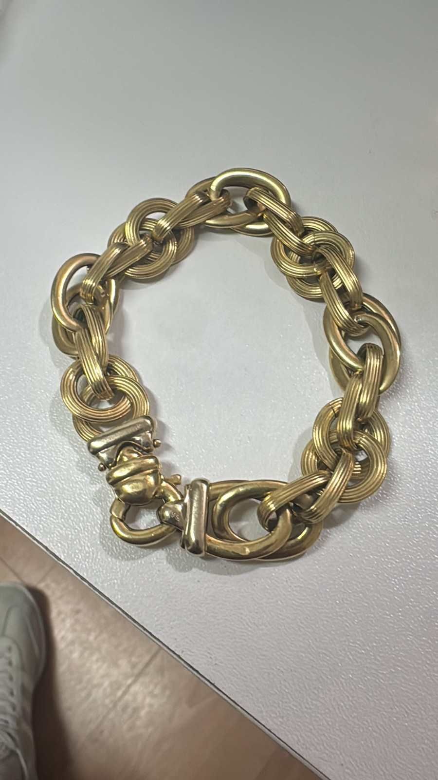 Pulsera de cadena de oro sobre una mesa clara