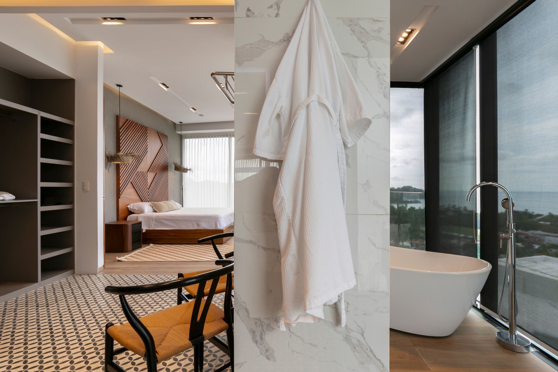 Collage: Bedroom, white robe on marble, and modern bathtub with ocean view.