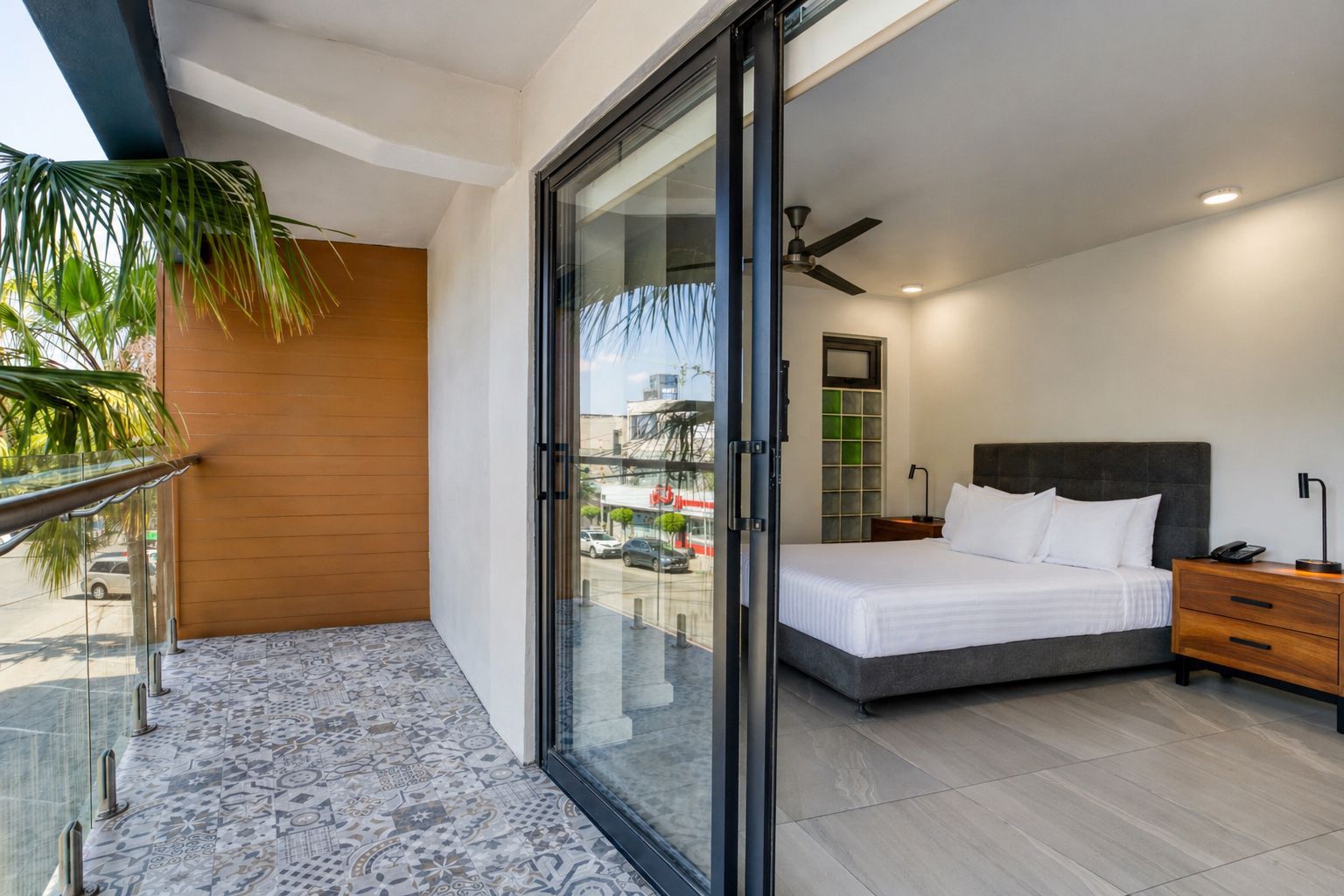 Modern bedroom with a queen bed, dark headboard, matching nightstands, pendant lighting, and geometric wall art.