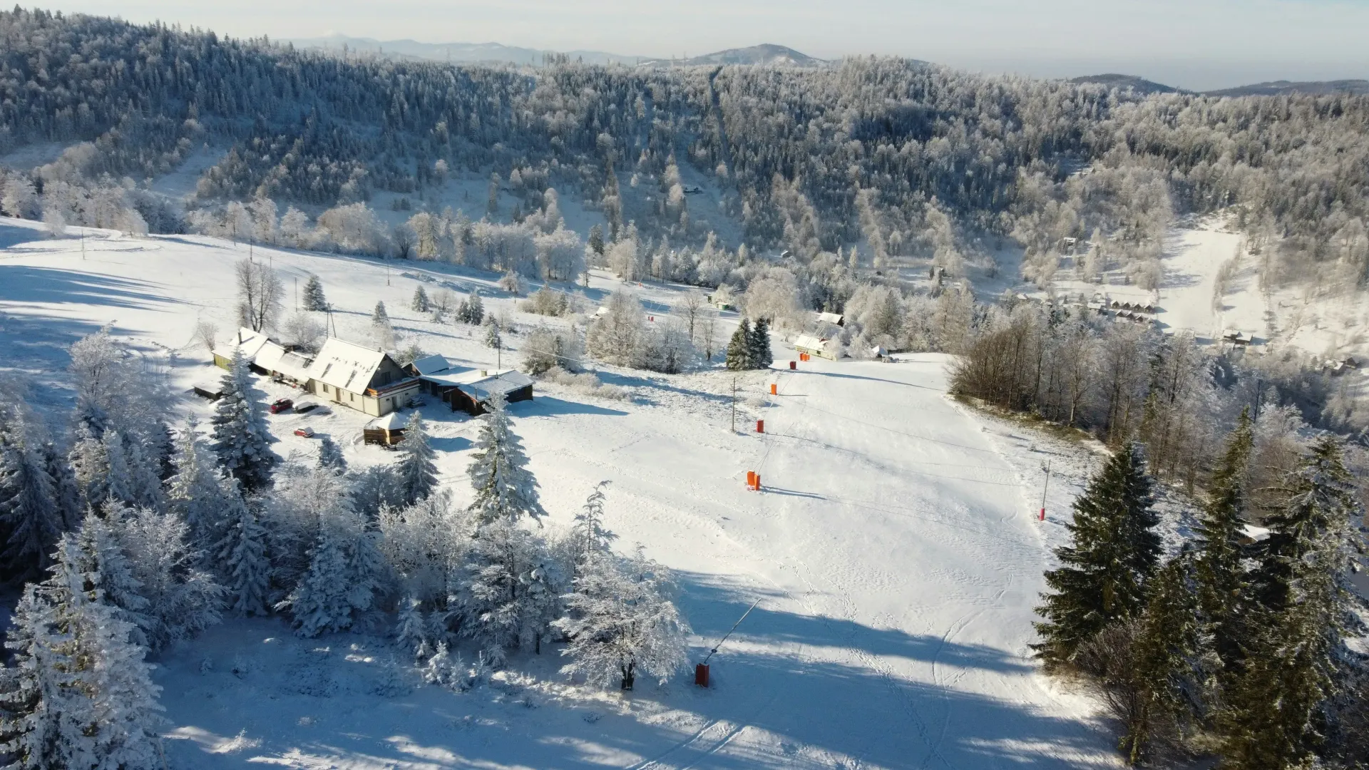 Snowy mountain landscape with buildings and trees, a ski resort in Szczyrk.