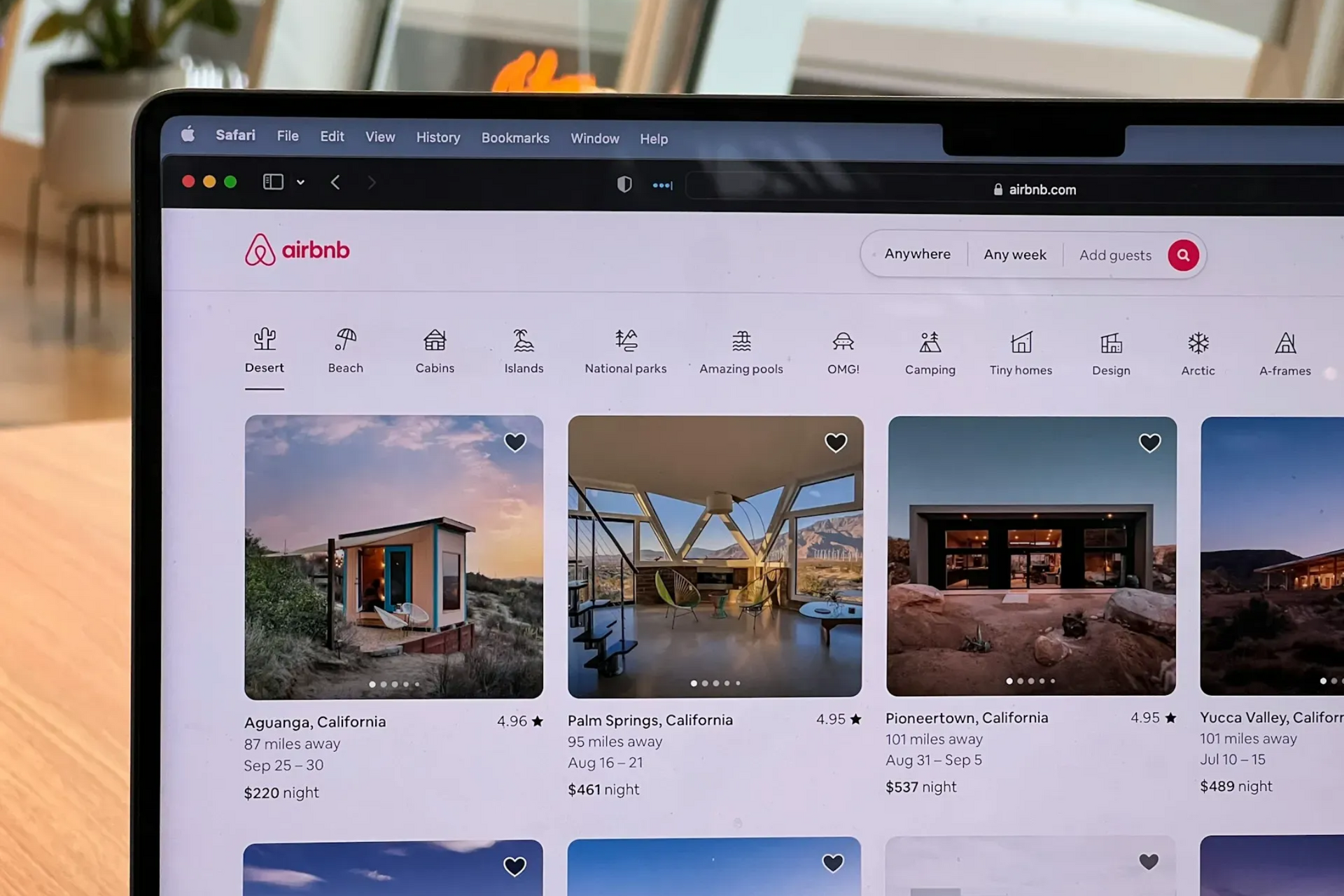 Airbnb website displayed on a laptop screen, showcasing vacation rental listings.