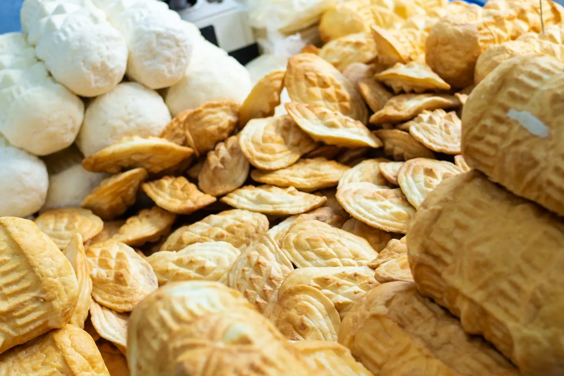 Smoked and white cheese: round, textured, stacked, close-up, assortment.