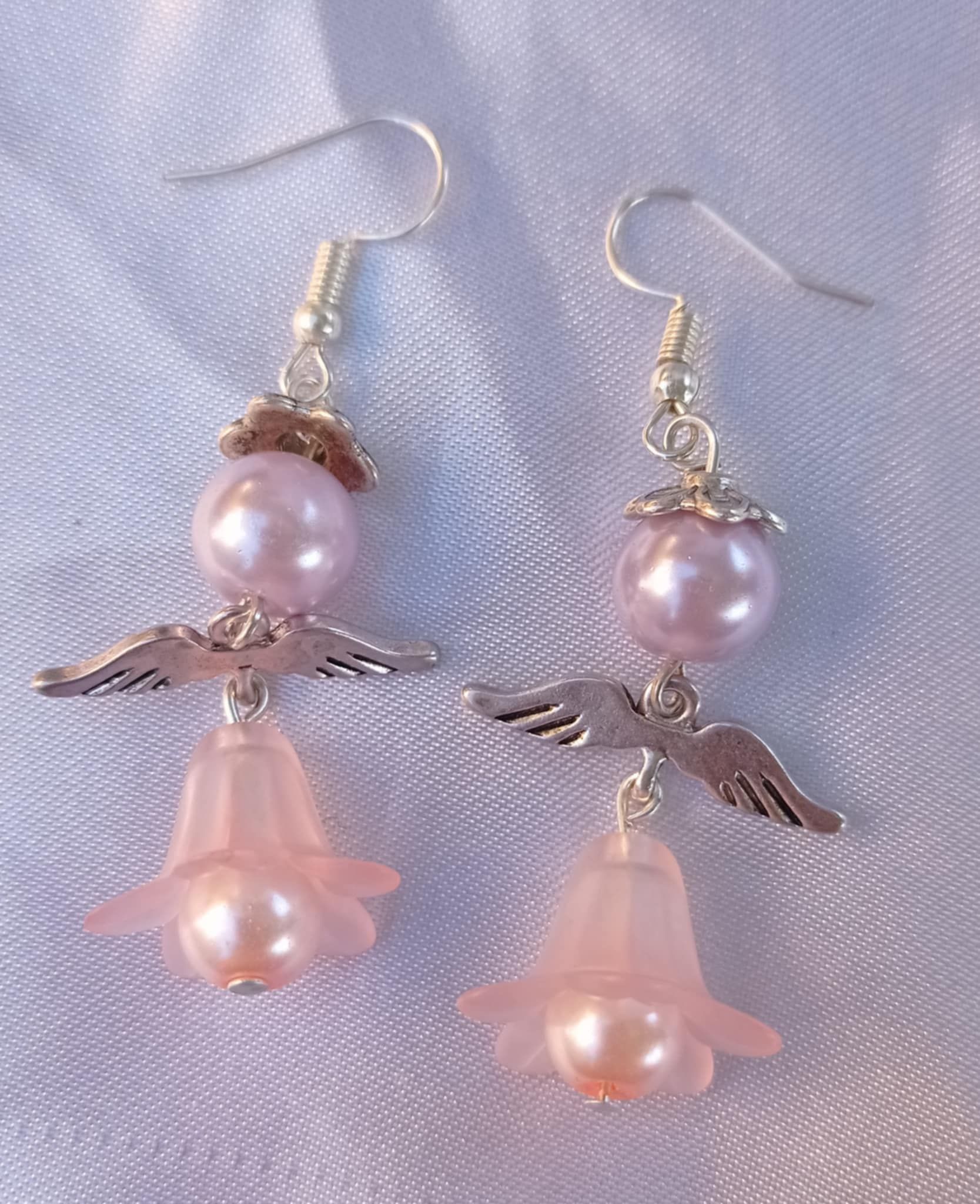 Boucles d'oreilles en argent avec pendentif en filigrane orné d'une fleur bleue.