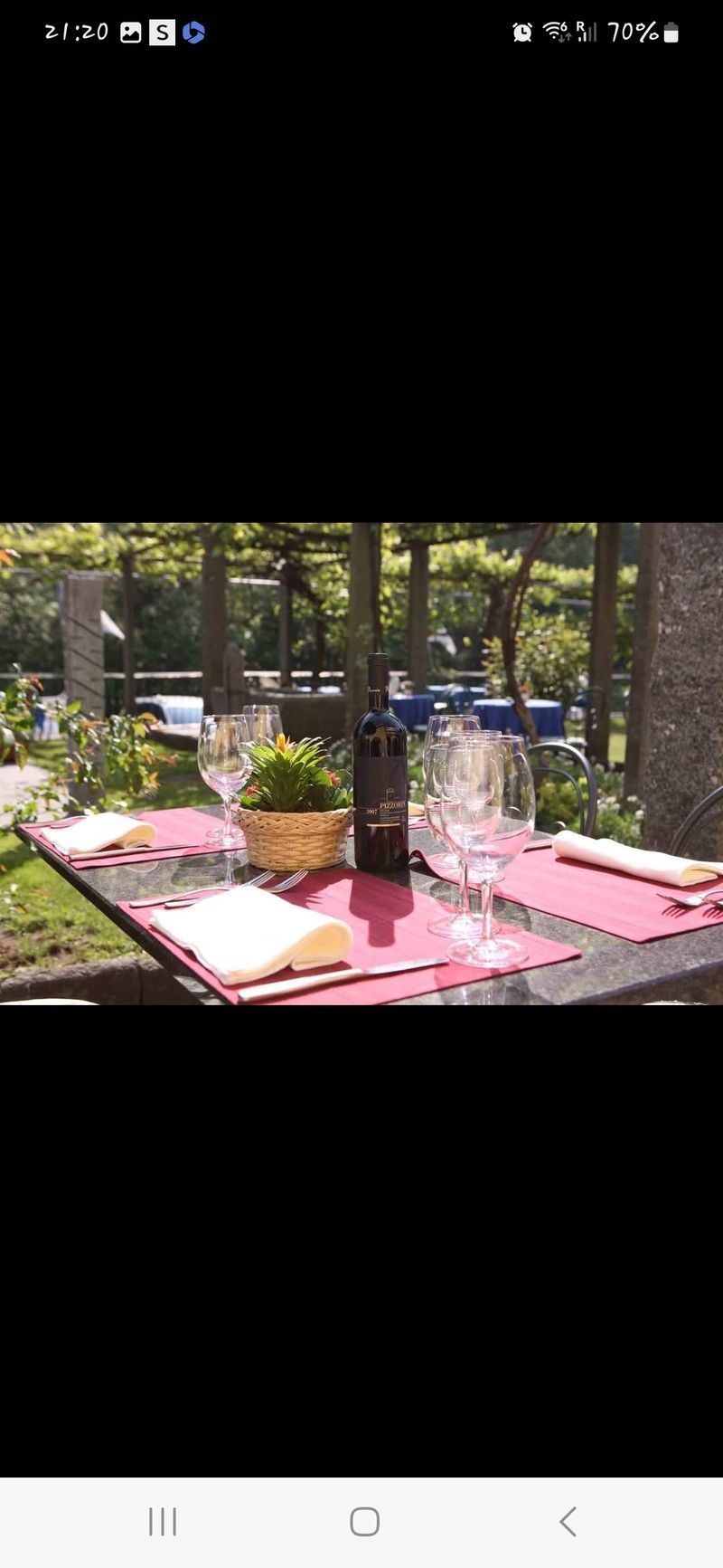 Un tavolo con una bottiglia di vino e dei bicchieri sopra.