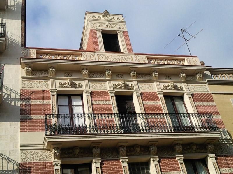 Un edifici de maó amb un balcó a la part superior
