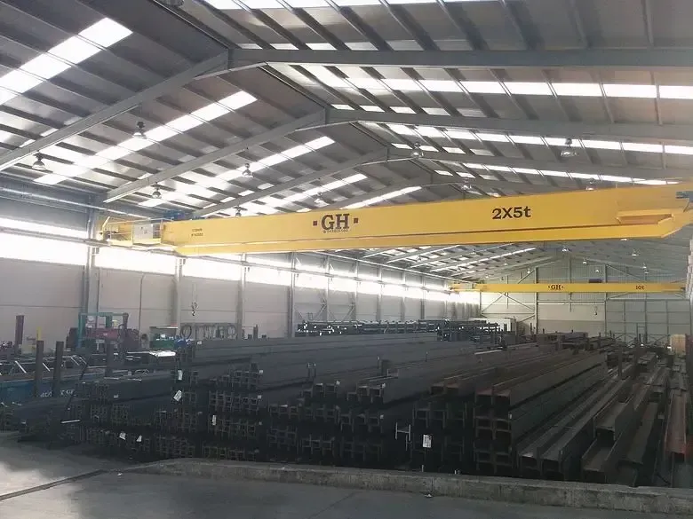 Un gran almacén lleno de tubos de acero y una grúa amarilla.