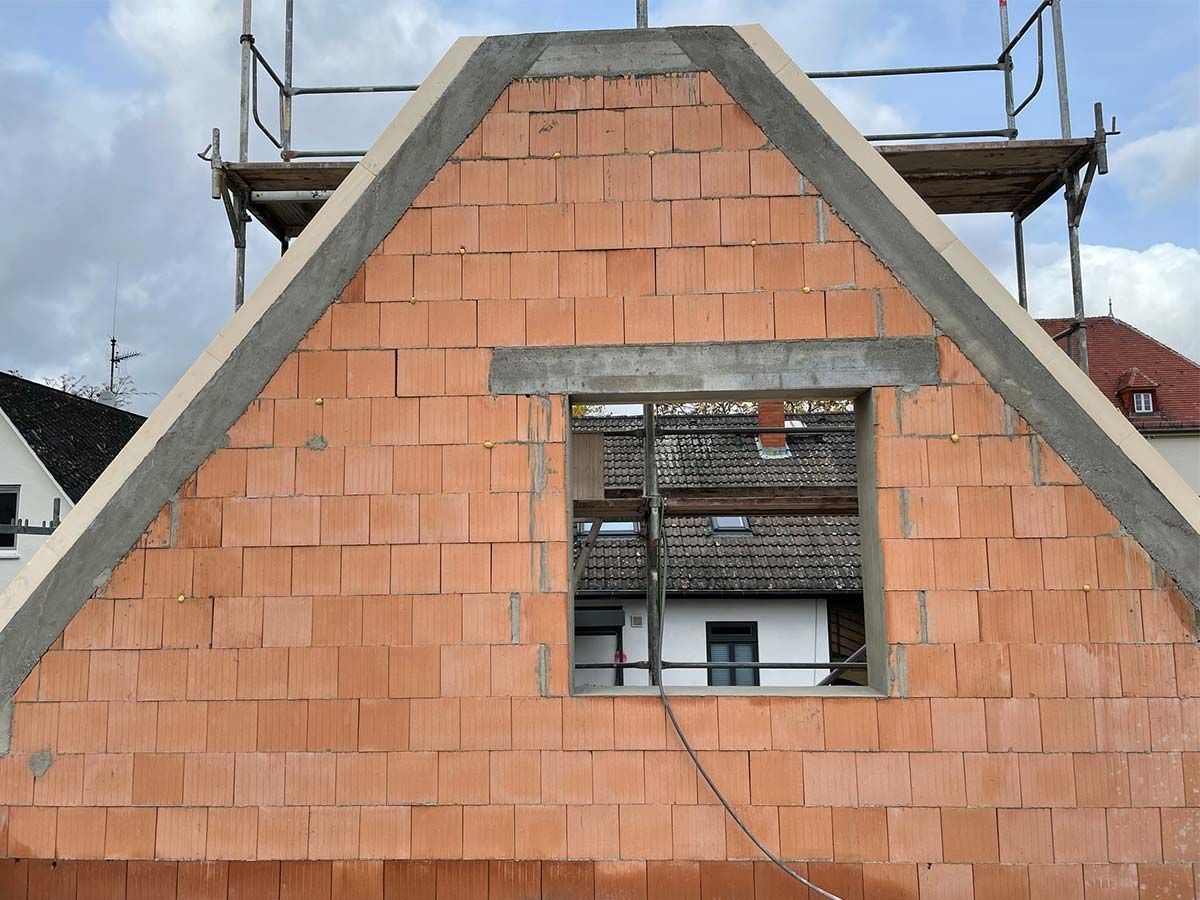 Ein Haus wird umgebaut, mit Gerüsten drumherum und einem Pool im Hinterhof.