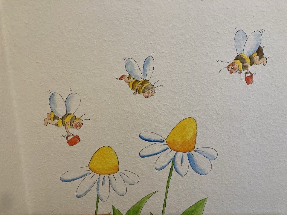 Gänseblümchen und Bienen auf einer Tapete in der Kinderarztpraxis BörchersGänseblümchen und Bienen auf einer Tapete in der Kinderarztpraxis Börchers
