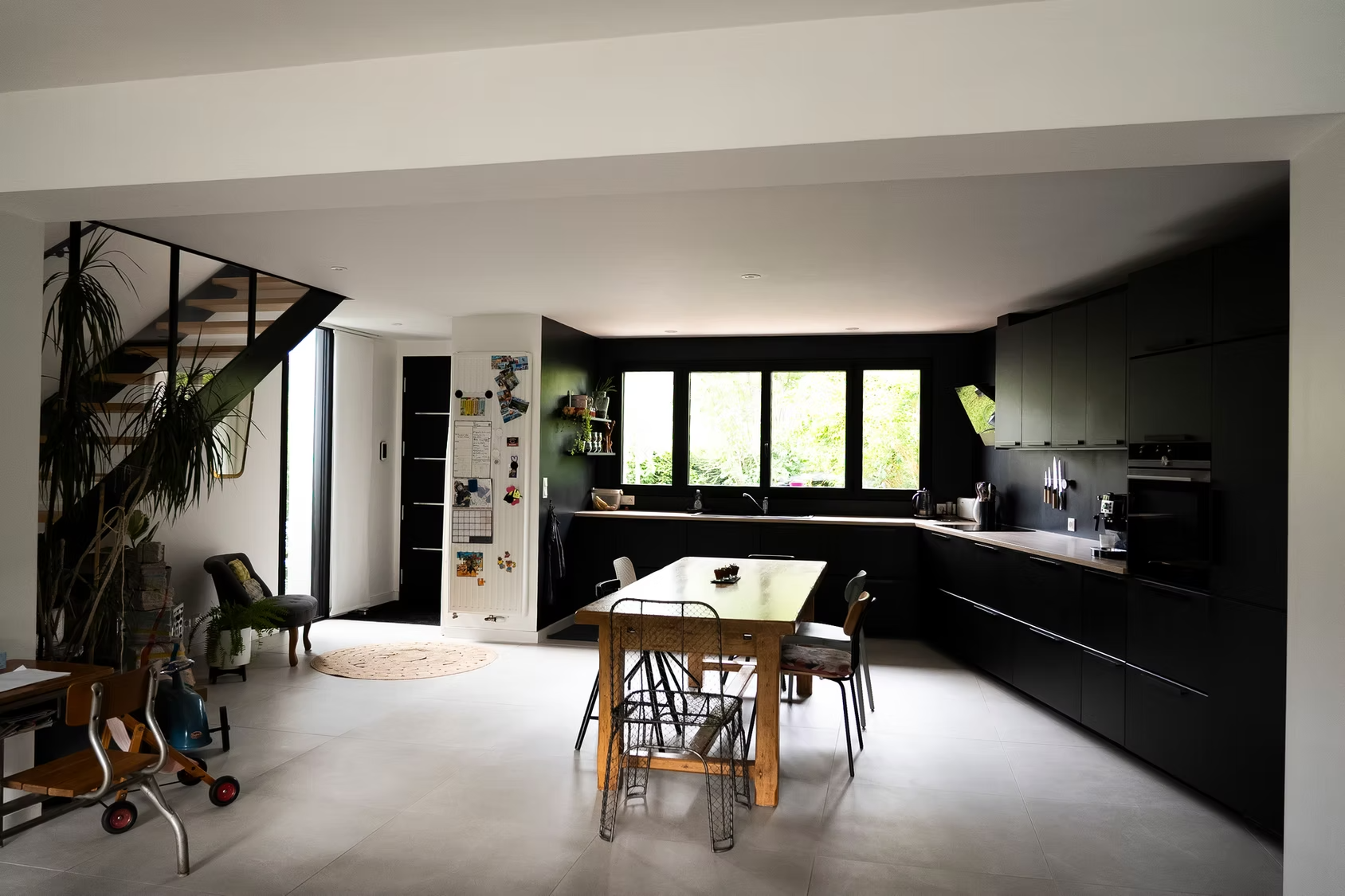 Une cuisine moderne ouverte avec des placards noir mat.