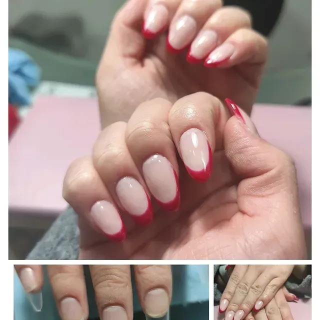 Un primer plano de las uñas de una mujer con una manicura francesa roja.