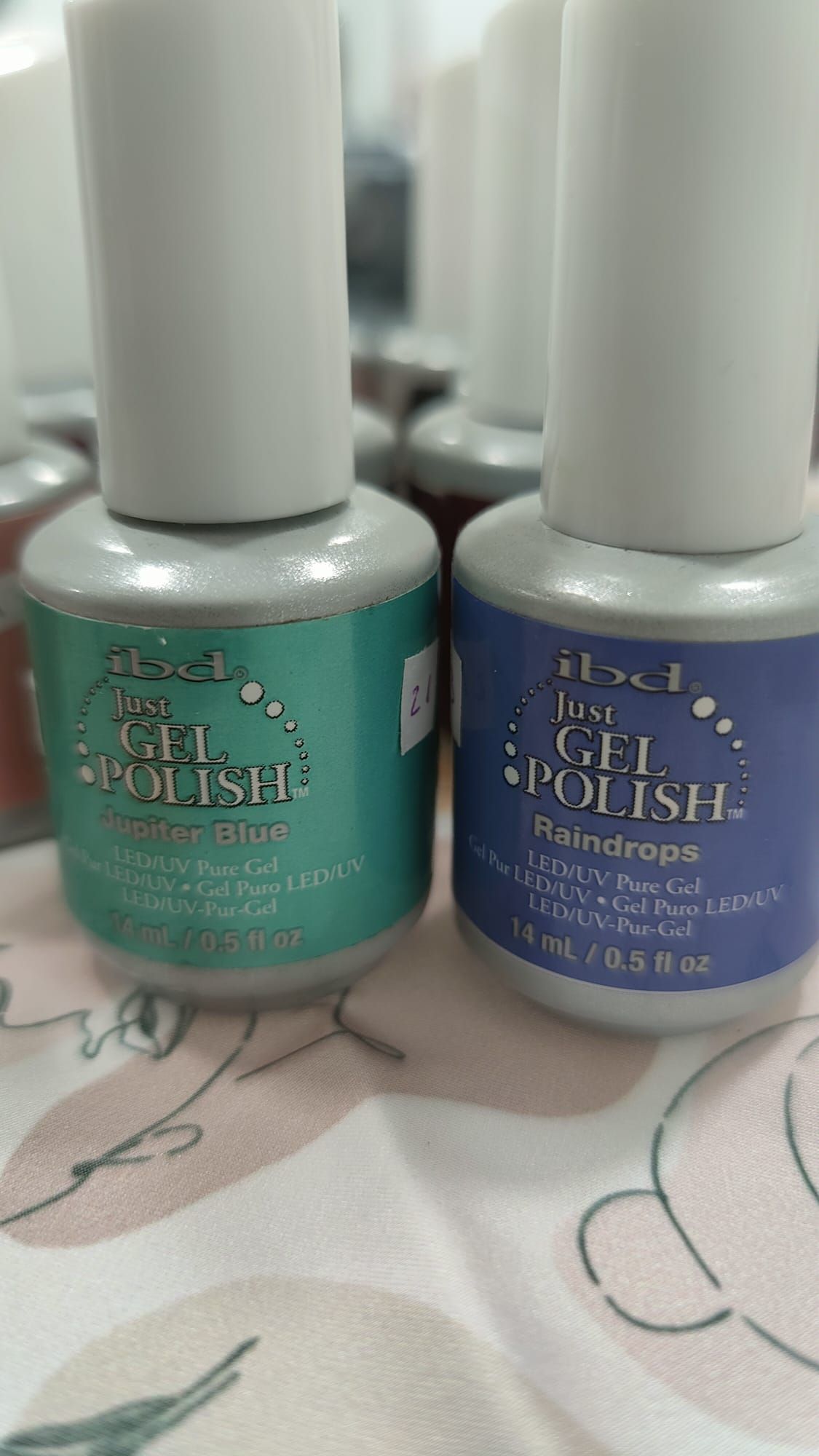 Hay dos botellas de esmalte en gel sobre una mesa.