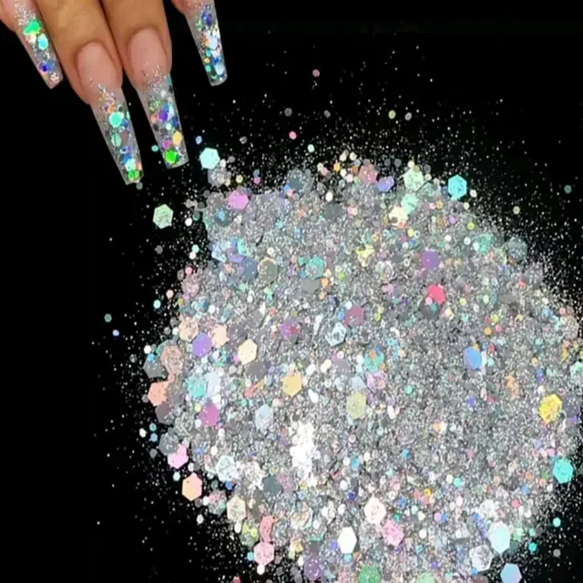 La mano de una mujer alcanza un montón de brillantina plateada.