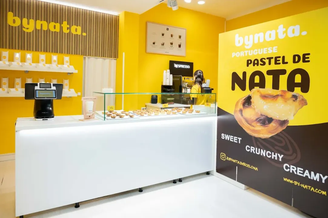 Una pastelería con un cartel que dice bynata pastel de nata