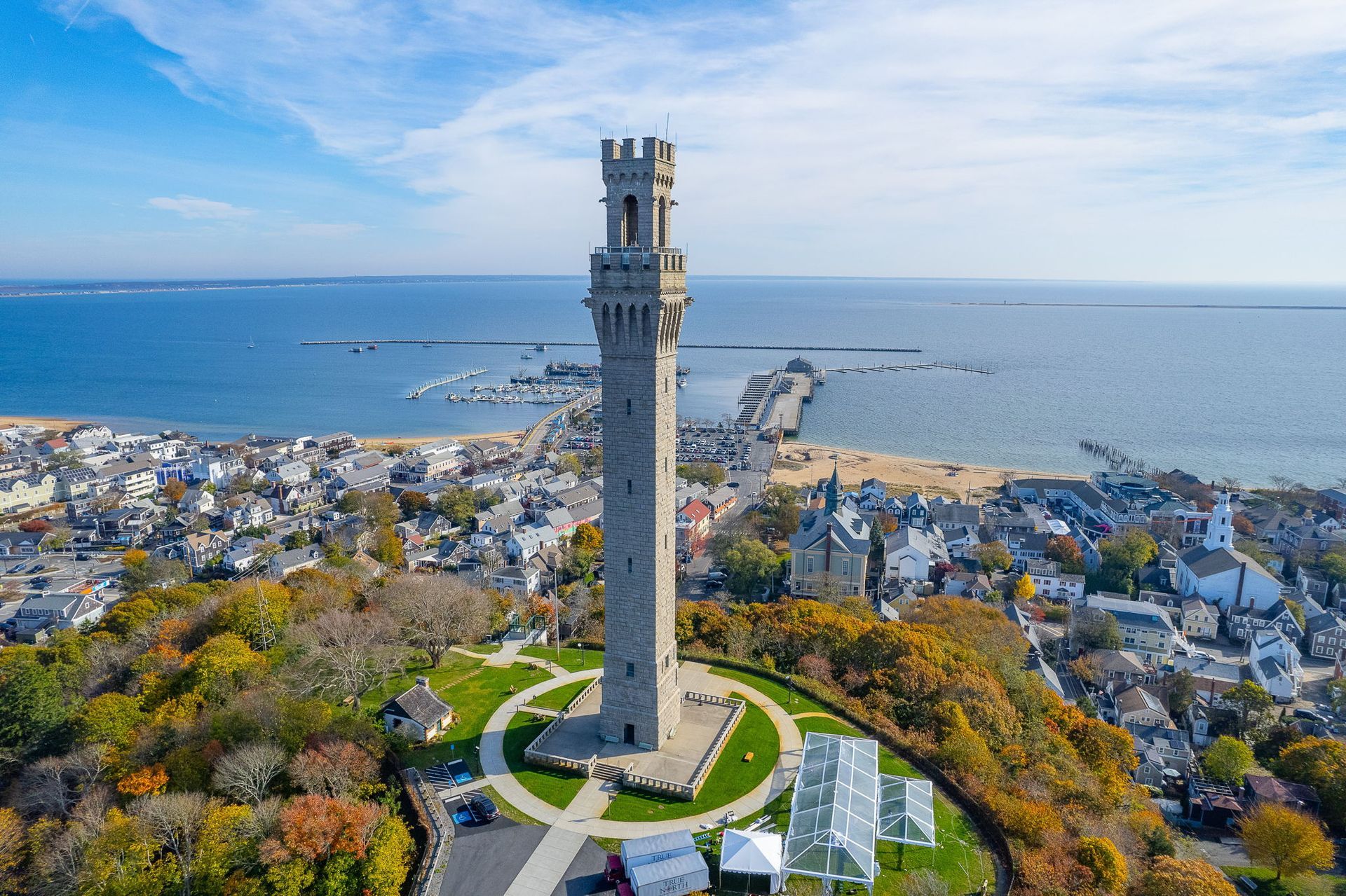 A porch with a couch and chairs and a view of the water.