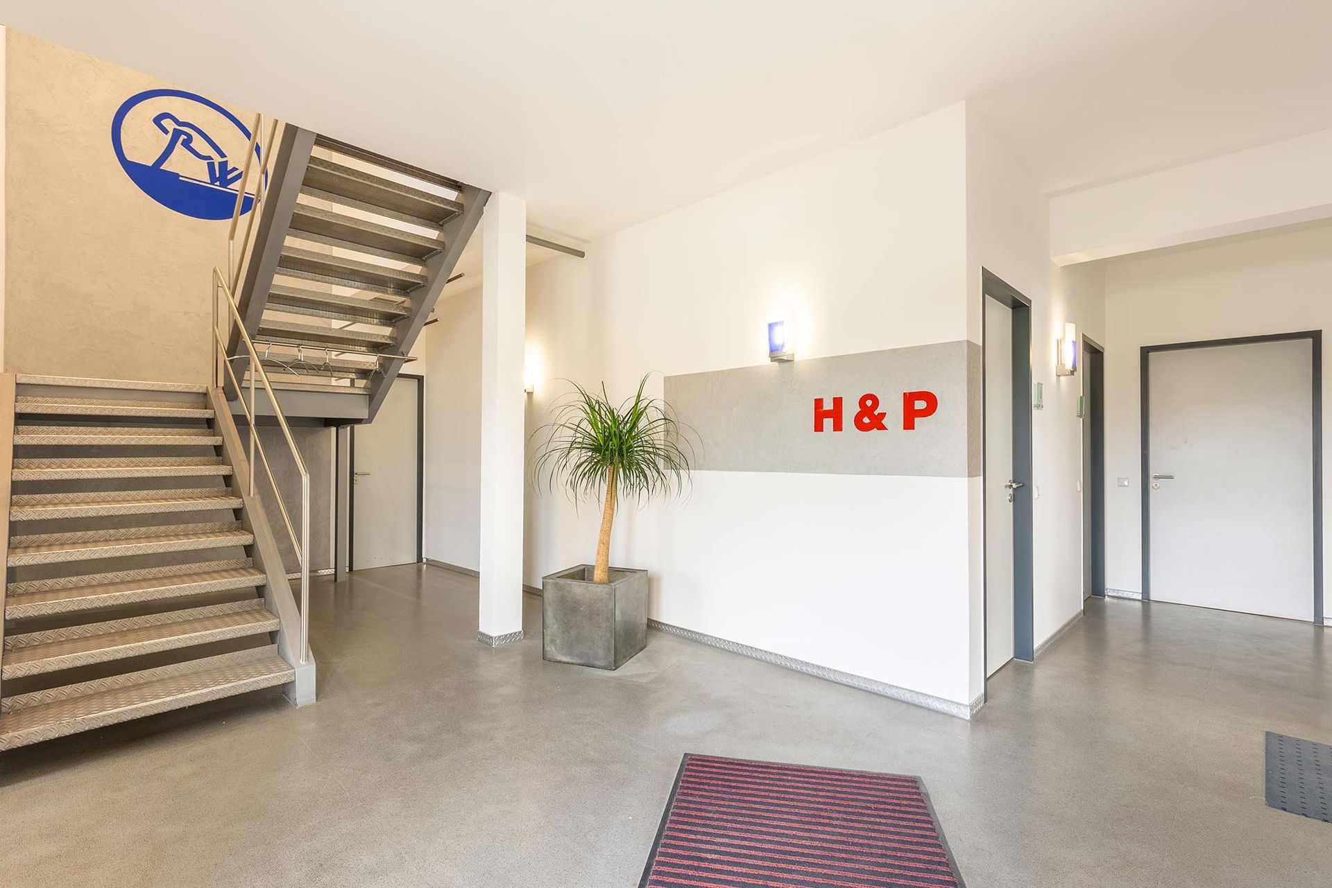 Ein Flur mit Treppen und einem Schild mit der Aufschrift „h & p“