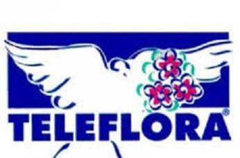 Logotipo de Teleflora con una paloma portando flores, fondo azul, texto "TELEFLORA".