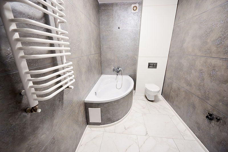 Ein Badezimmer mit Badewanne, Toilette und Handtuchhalter.