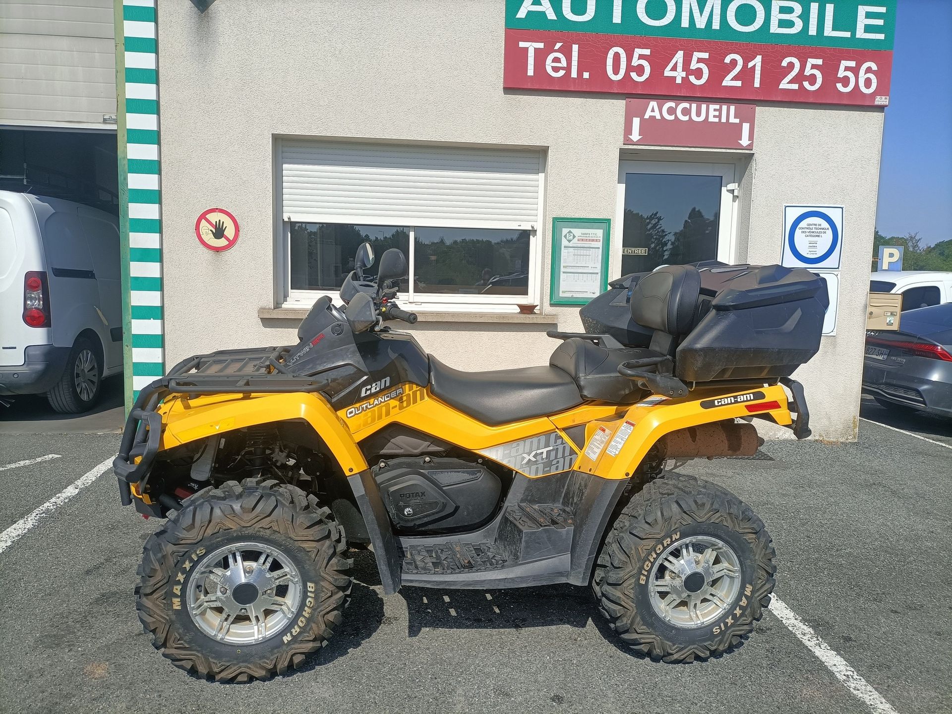Un quad jaune et noir est garé devant le centre de contrôle.